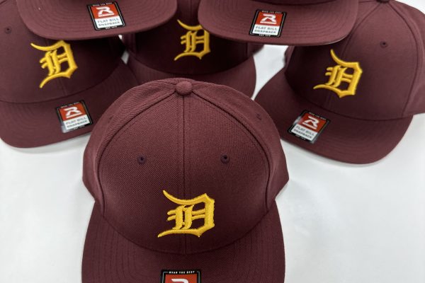 Custom embroidered high school baseball caps featuring detailed stitching and detailed team logos, perfect for showcasing school spirit and team pride on and off the field